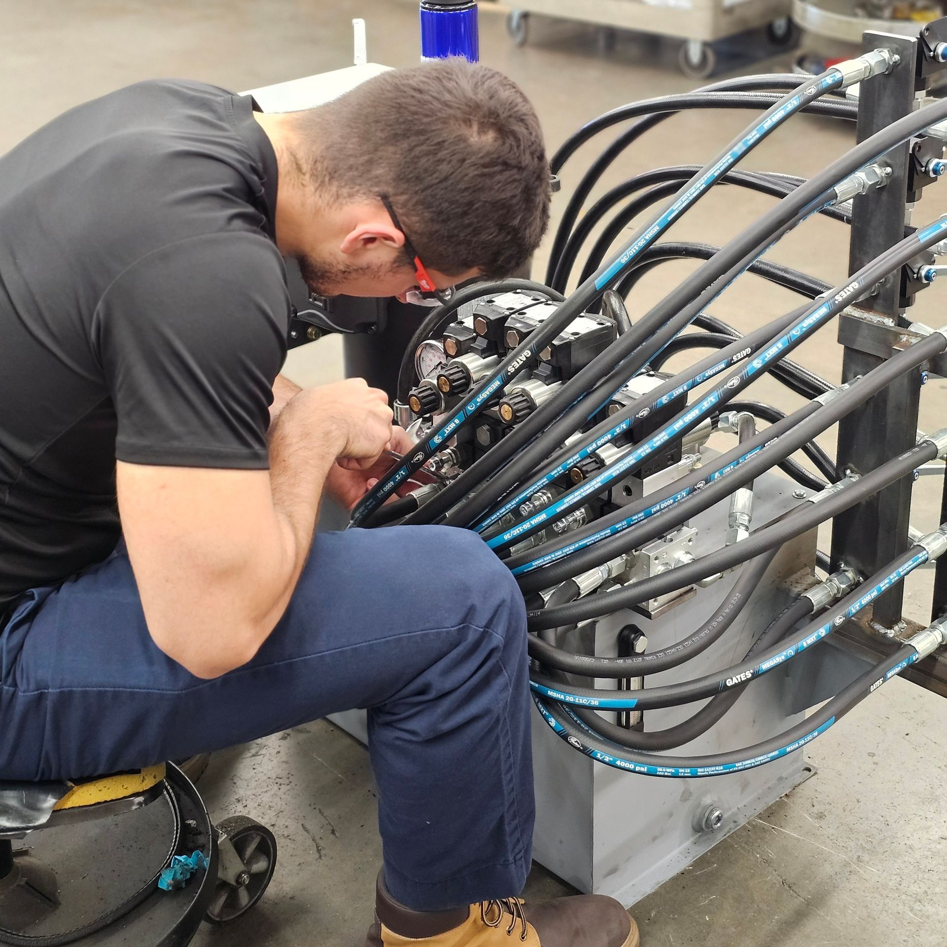 A man in a black shirt is working on a machine