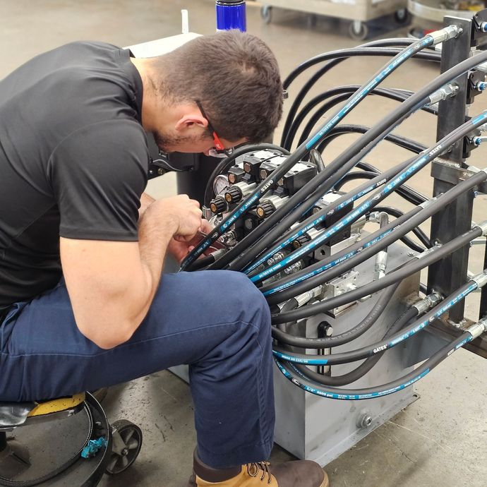 A man in a black shirt is working on a machine