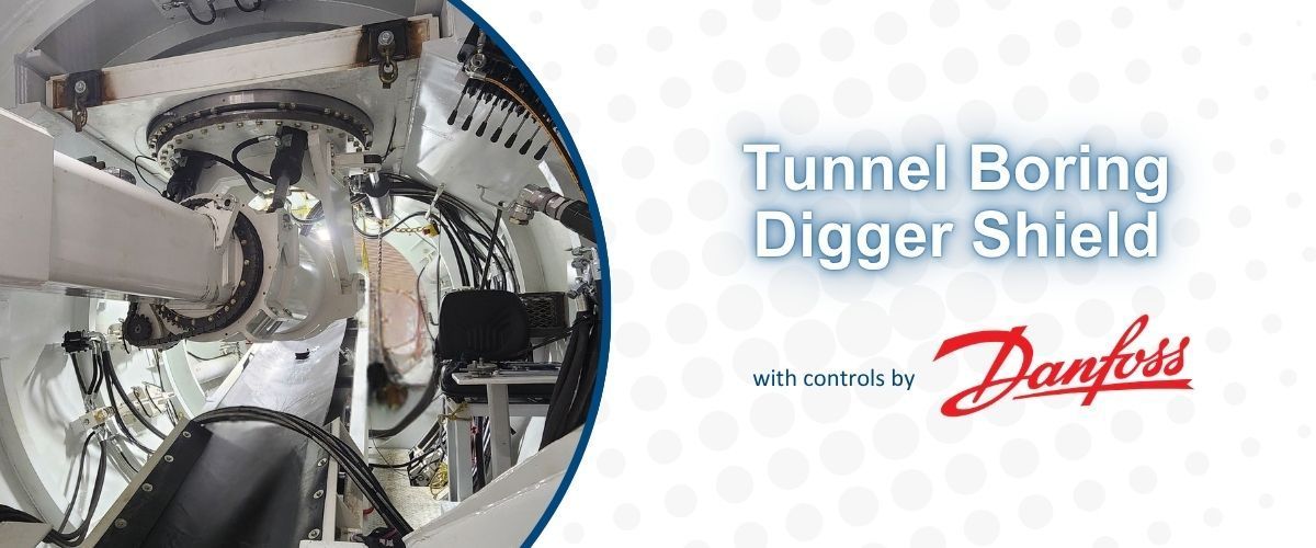 Tunnel boring digger shield with Danfoss logo and machinery close-up