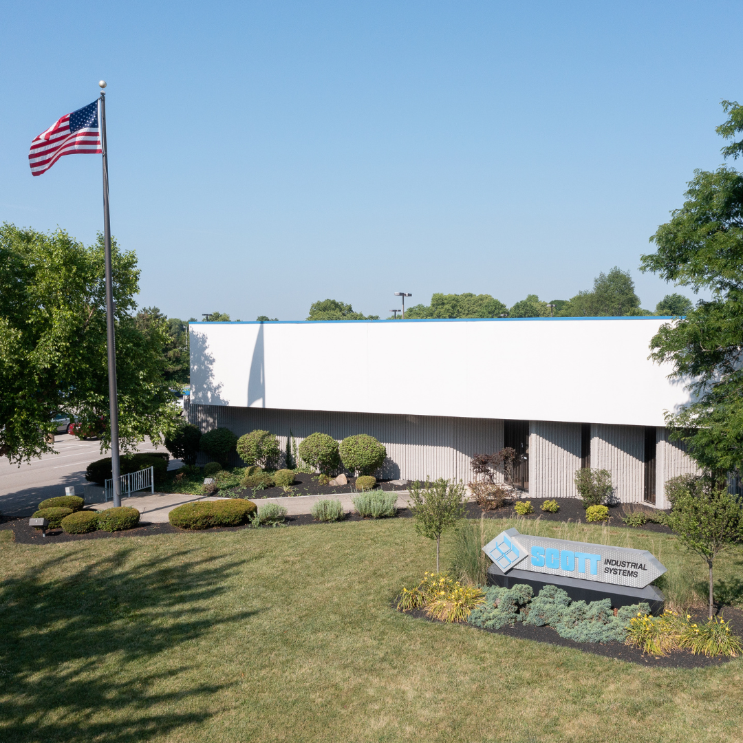 A large white building with an American flag flying in front of it