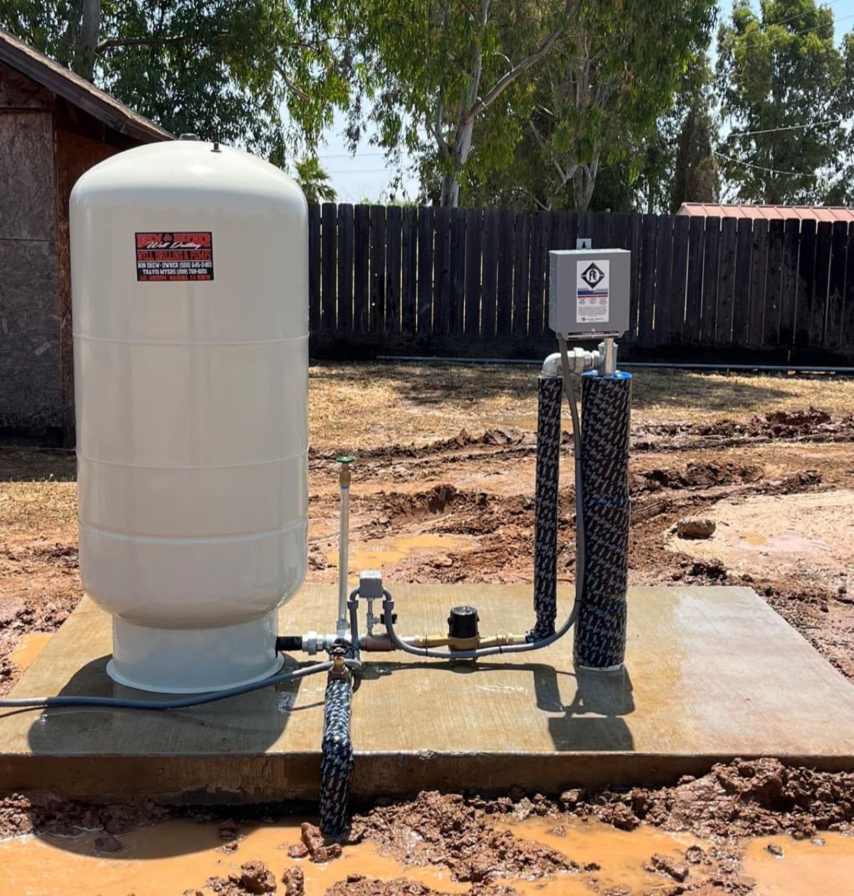 A close up of a water pump in a field.