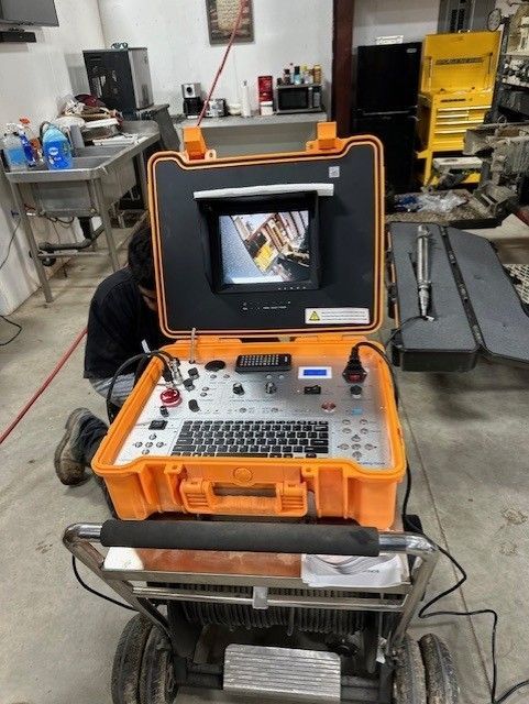 A man is working on a machine in a garage