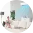 Bright modern room with white chairs, a sofa, and a large blue abstract wall panel.