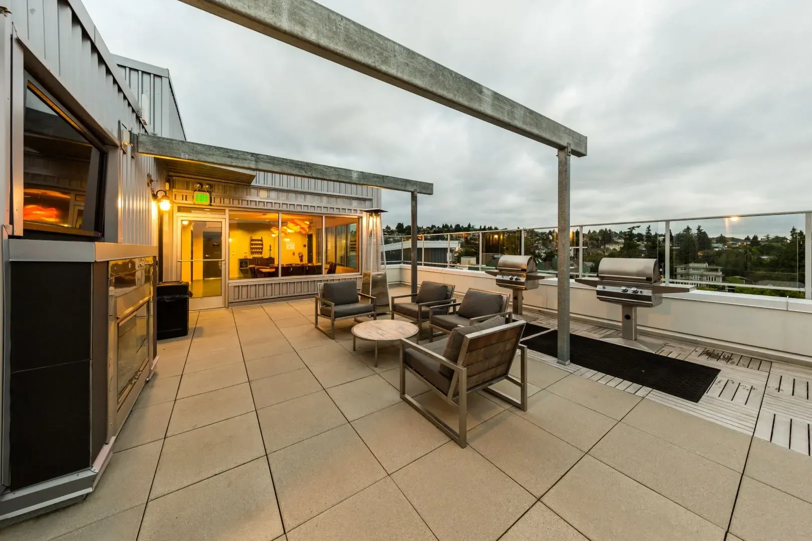 Rooftop patio with seating and grills