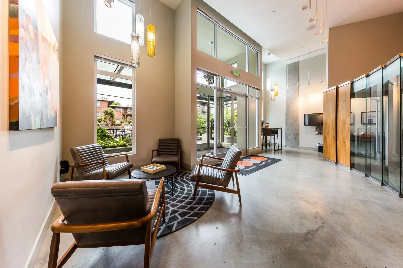 Modern apartment building lobby with contemporary seating area and glass partitions.