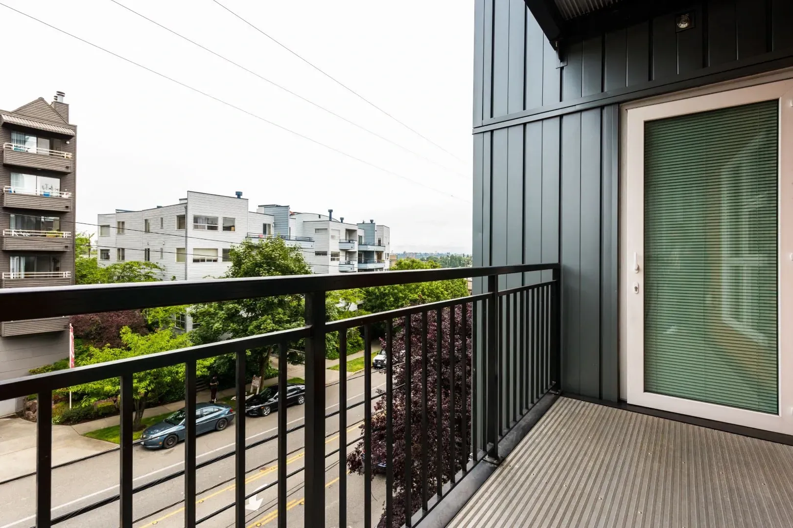 Balcony view of street and surrounding buildings from an apartment.