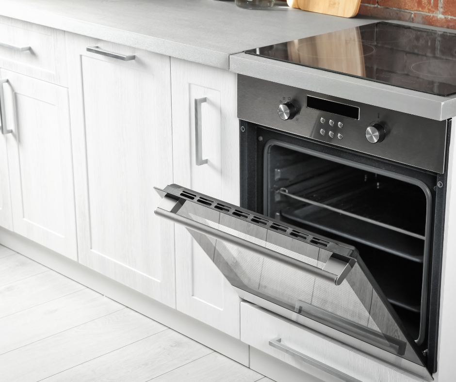 An oven is open in a kitchen with the door open.