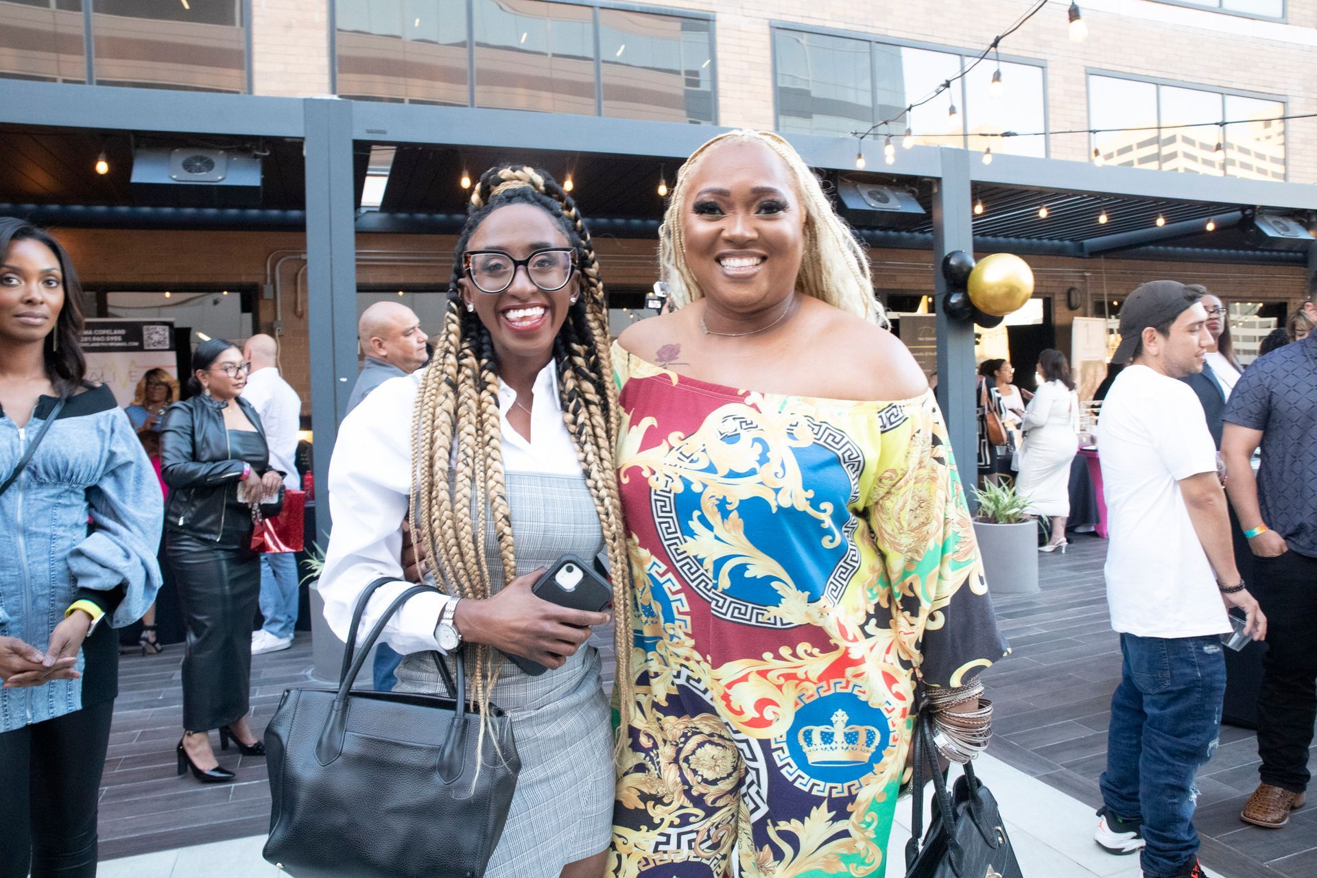 Two women are posing for a picture together at a party.