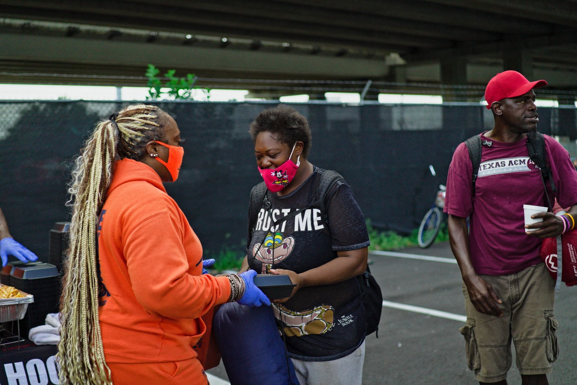 A woman wearing a mask is talking to another woman.