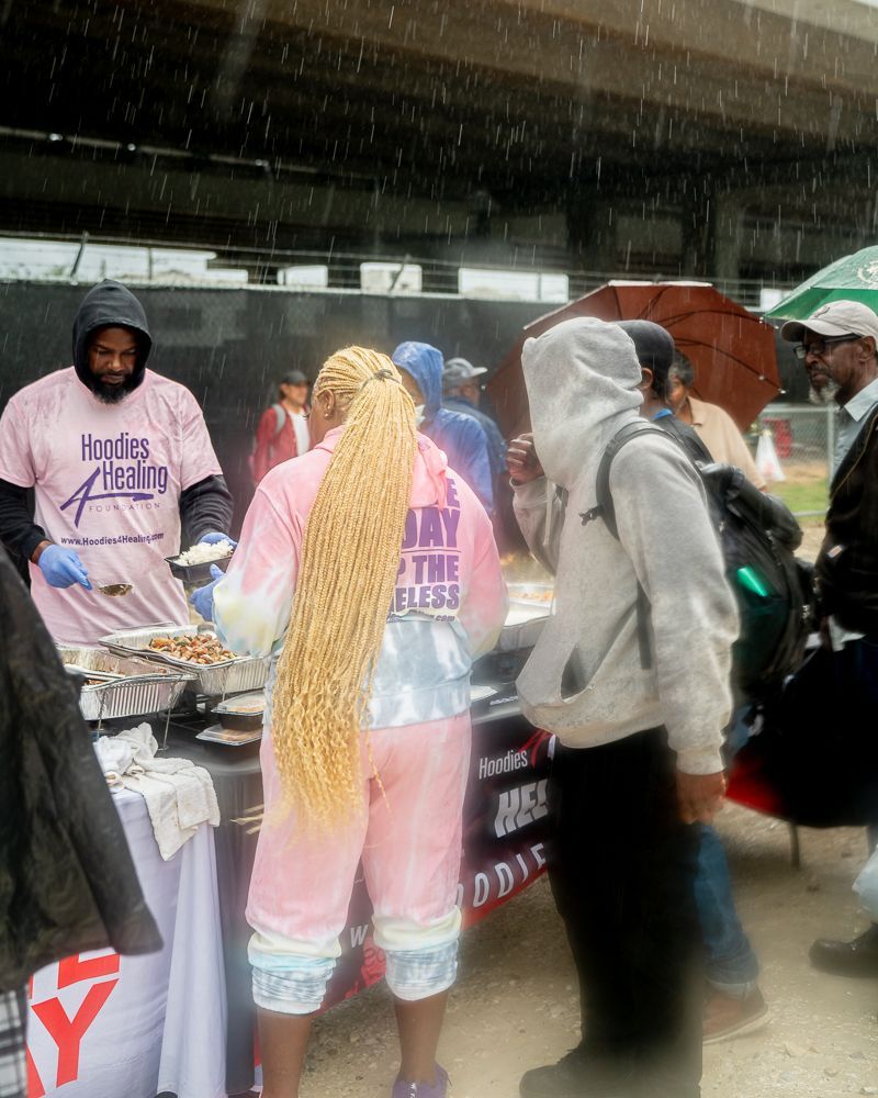 A woman wearing a pink hoodie that says 