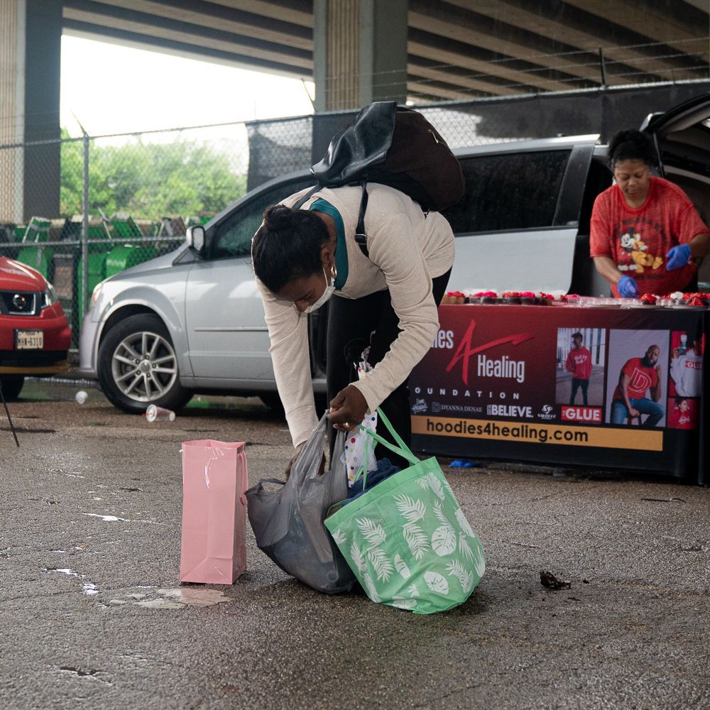 A man is kneeling down in front of a table that says healing