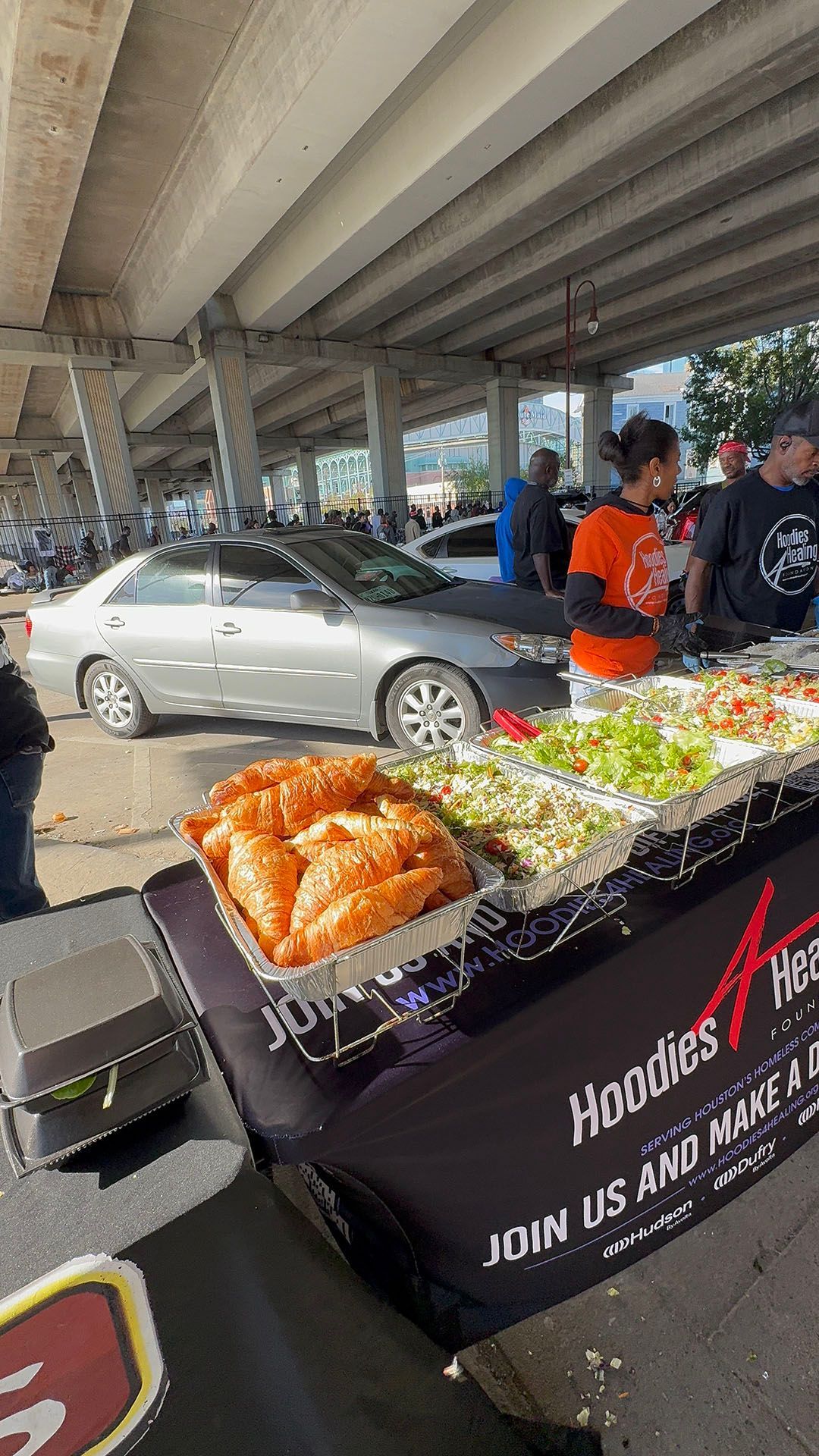 A man is standing in front of a table with food on it.