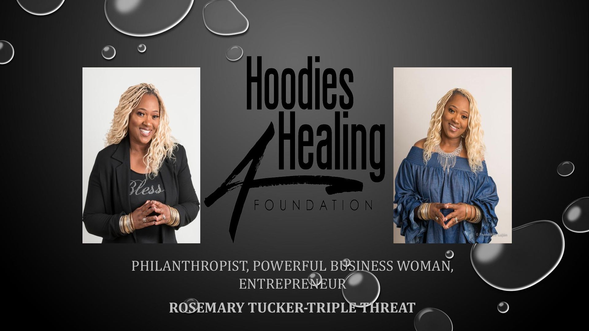A woman is standing in front of a sign that says hoodies healing foundation.
