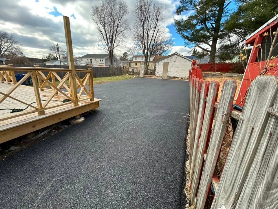 Asphalt patch repair being applied to a residential driveway in Bristol, PA