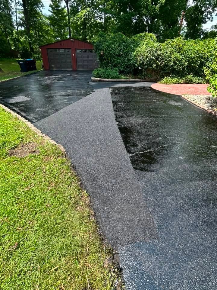 Professional asphalt sealcoating applied to a driveway in Bristol, Pennsylvania