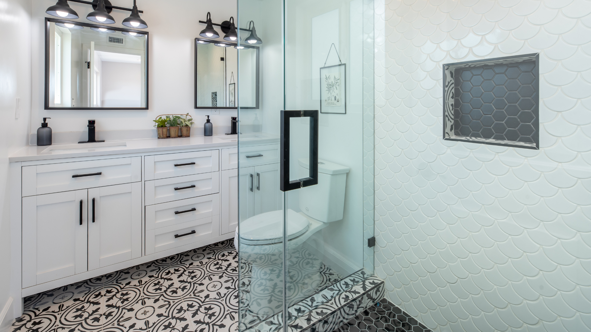 A bathroom with a toilet , sink , mirror and walk in shower.