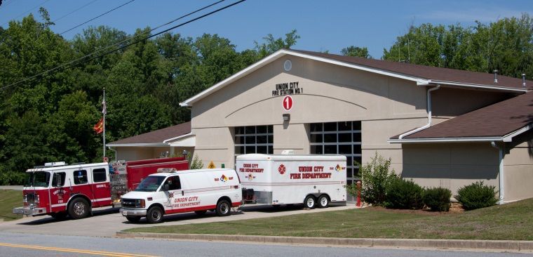 a fire truck and ambulance are parked in front of a fire station