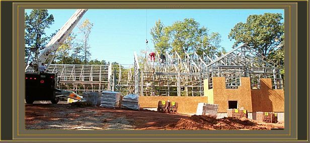 a picture of a building under construction with a crane in the foreground