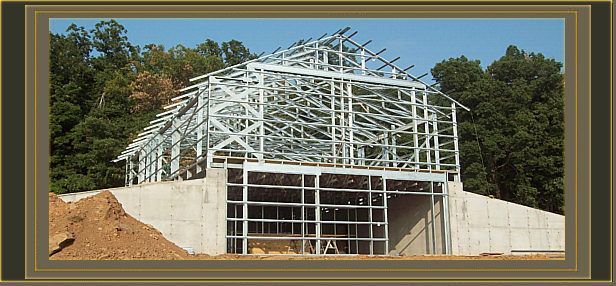 a picture of a building under construction with trees in the background