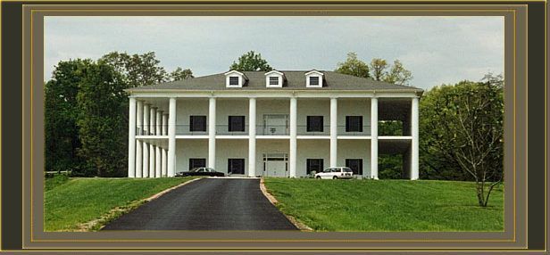 a large white house with a driveway leading to it