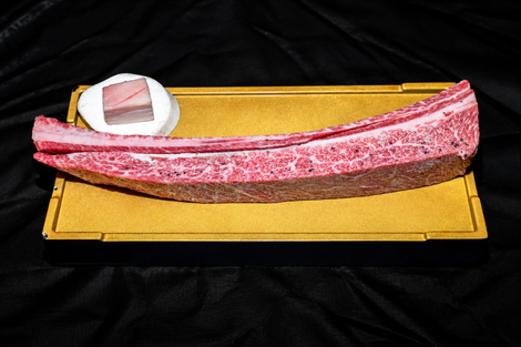 Long pink marble slab on a gold tray with a small white dish at one end