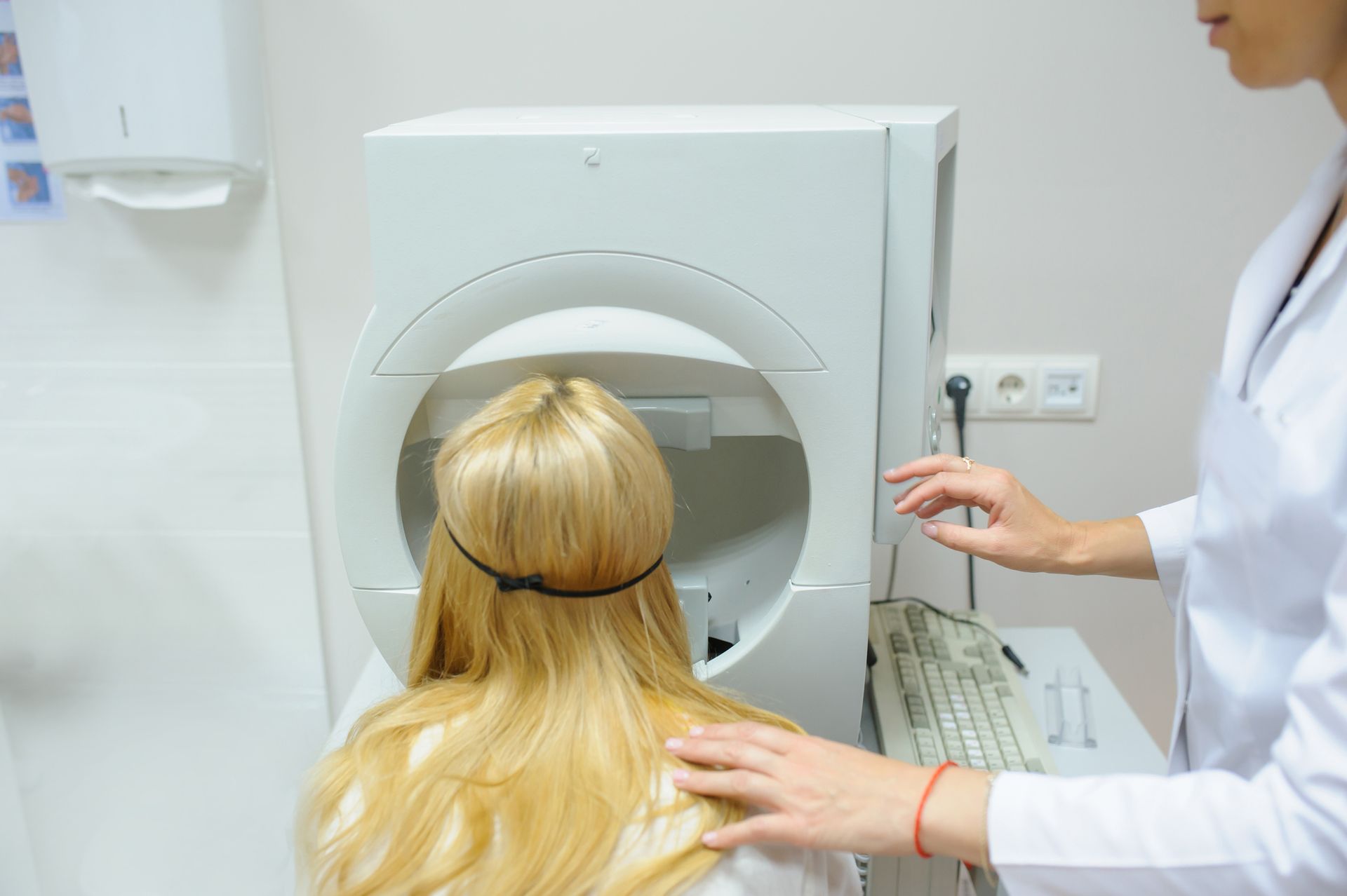 A doctor is examining a patient's eye with a machine.