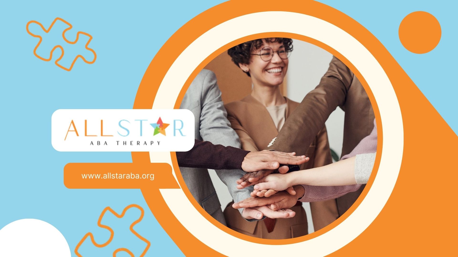 A group of people are putting their hands together in a circle.