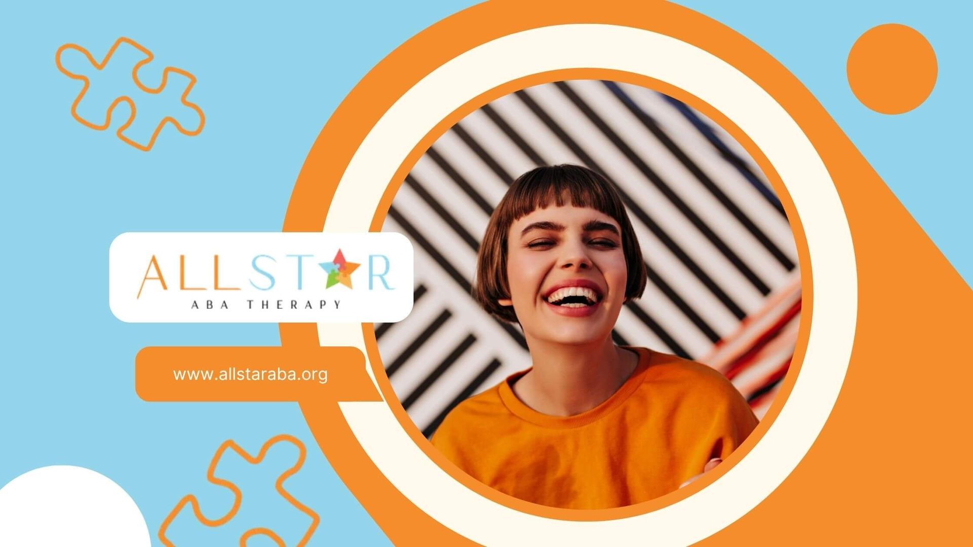 Young woman with autism laughing with short hair and bangs against a graphic wall.