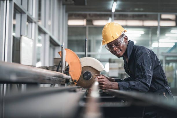 Engineer wearing safety uniform control operating lathe grinding