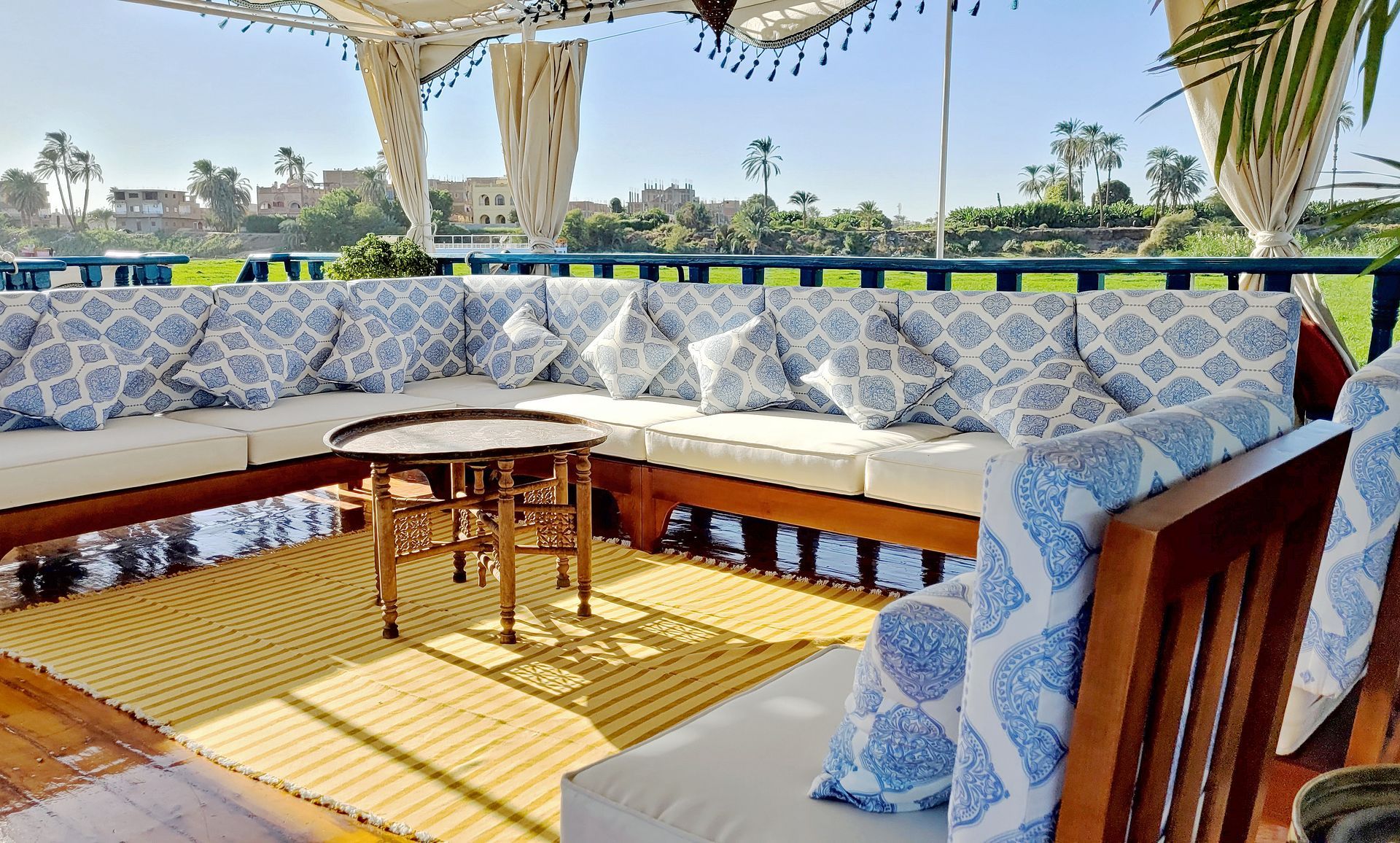 - A picture of a deck lounge area on a historic Egyptian boat
- The boat is called Dahabiya Kingfisher and was built in 1899
- The boat offers private cruises along the Nile river between Luxor and Aswan