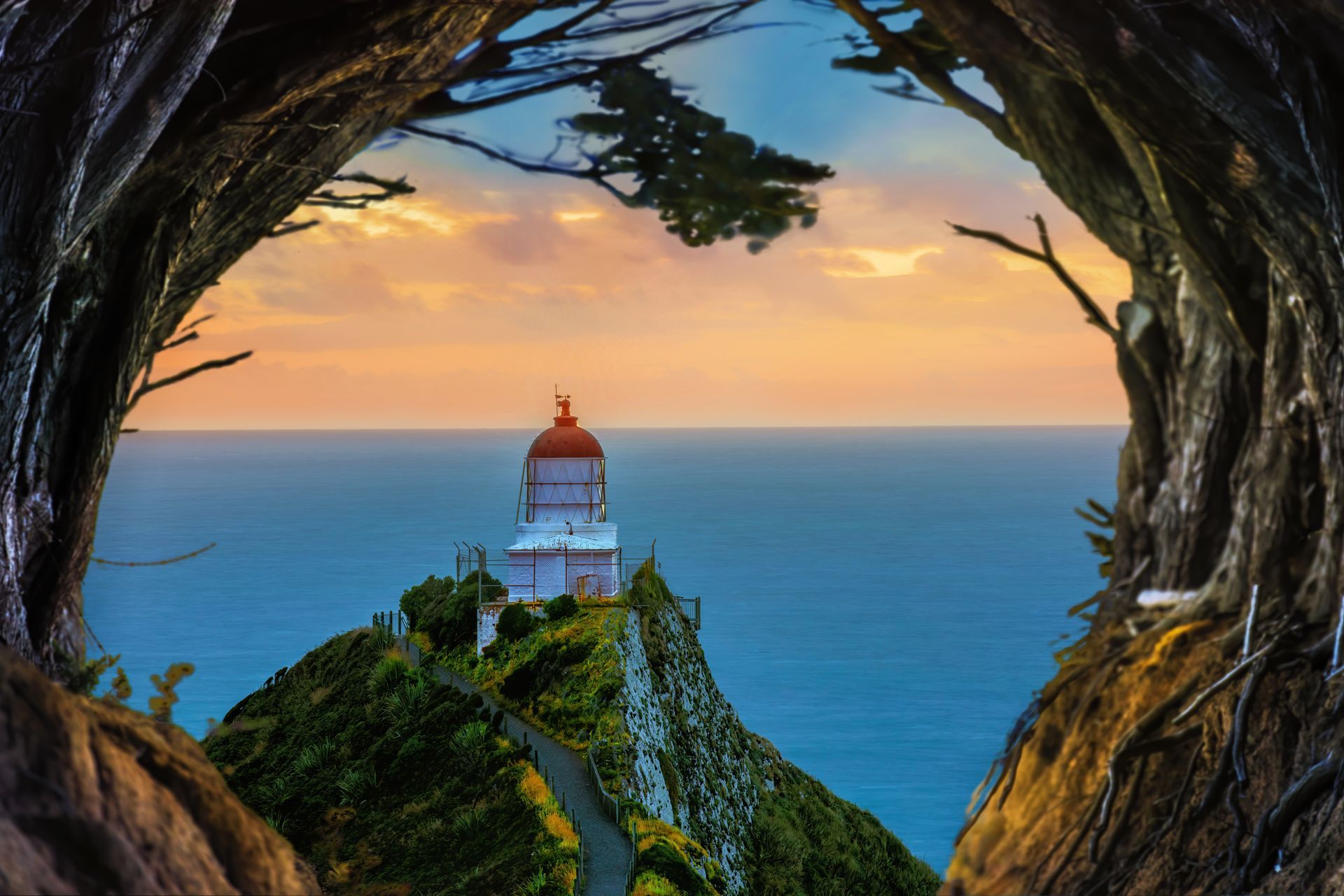 A lighthouse on top of a hill overlooking the ocean