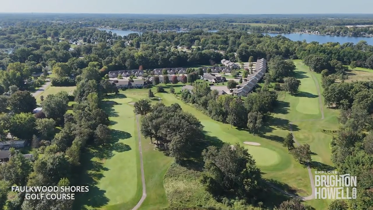 Aerial view of Oakwood Shores Golf Course in Brighton, Michigan, featuring green fairways, trees, and nearby housing.