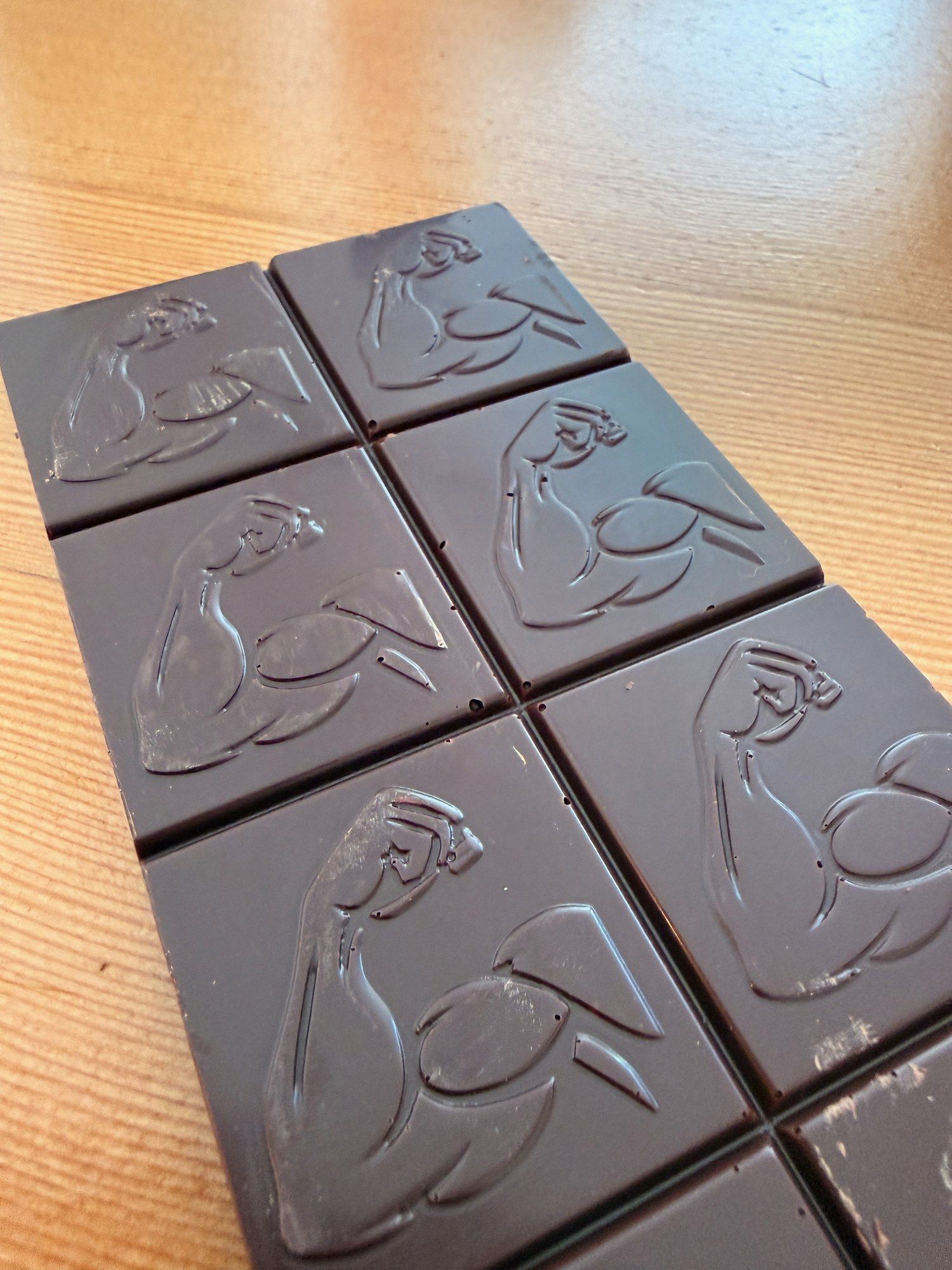 Swole Bar dark chocolate bar with embossed flexed-arm squares