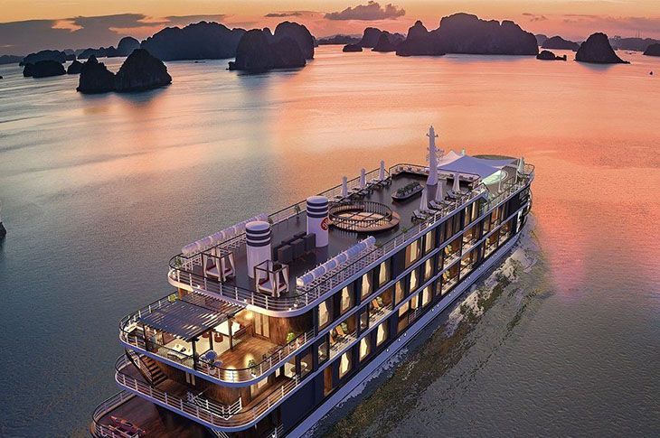 Cruise ship sailing across calm water with rocky islands at sunset. Asia Cruise
