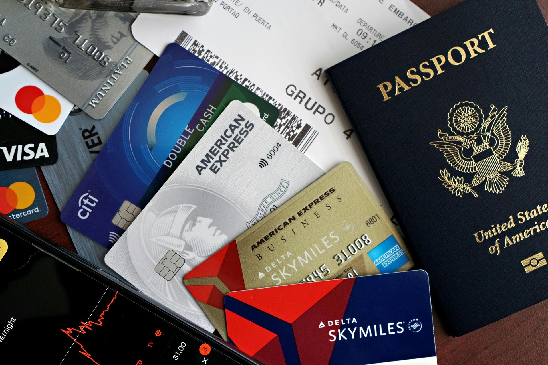 Passport, credit cards, and receipts on a surface.