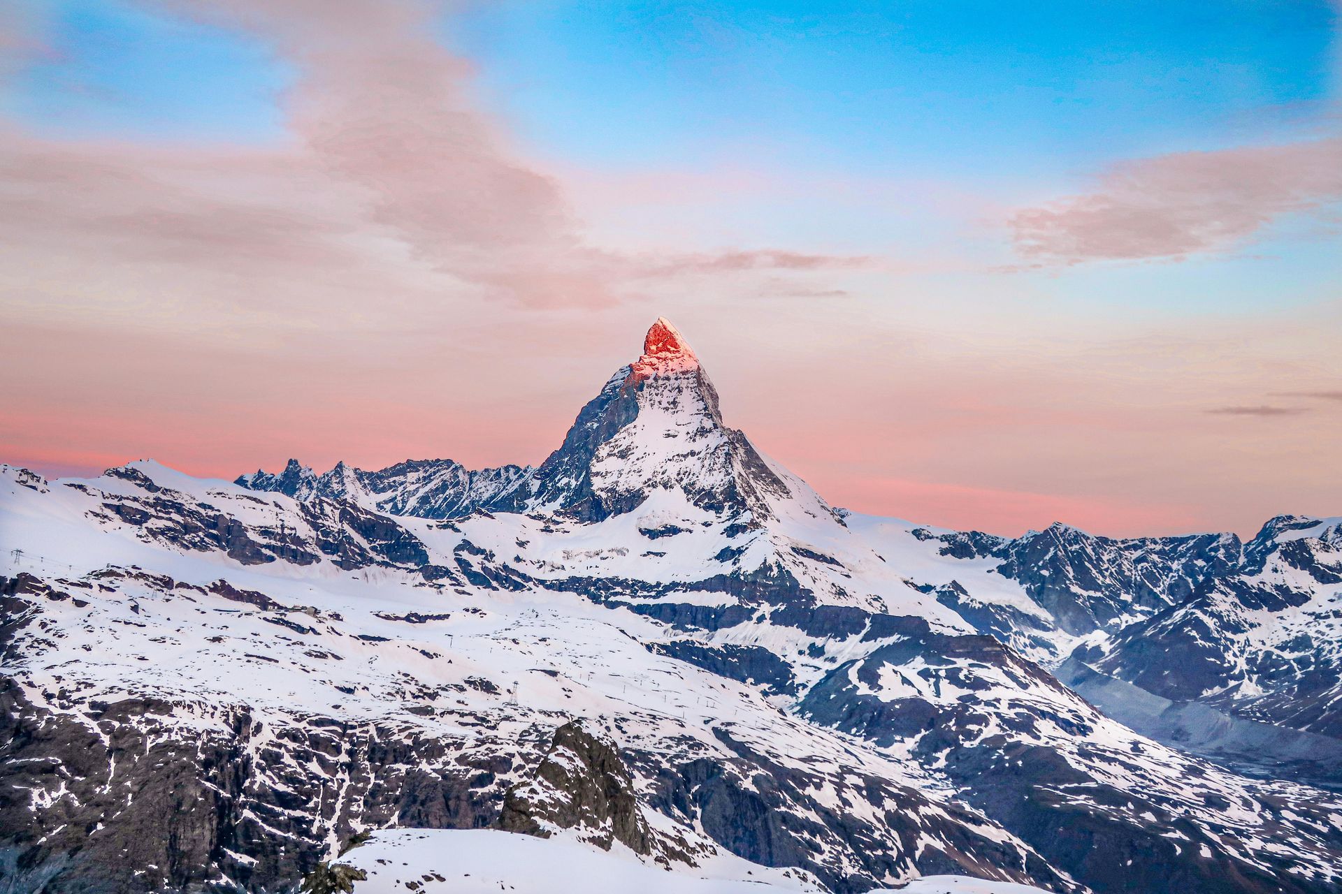 Snow-covered mountain peaks under a clear blue sky.