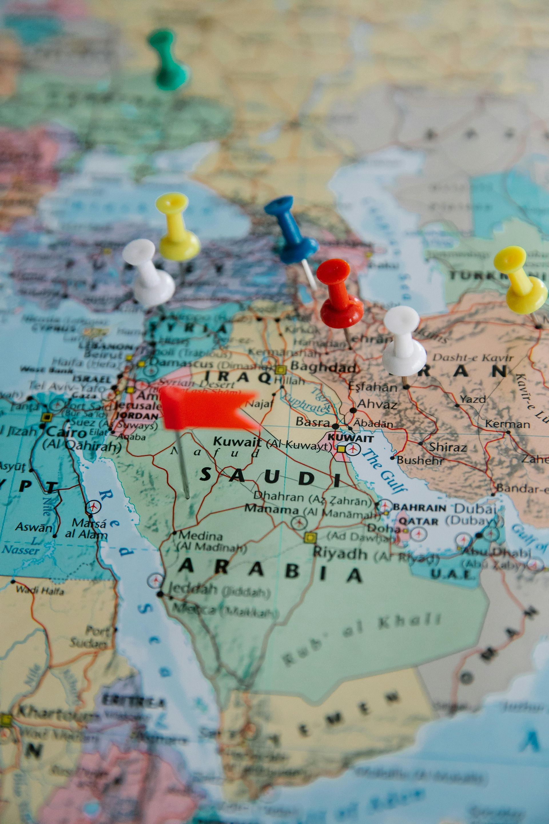 Map of the Middle East, pushpins marking locations, with