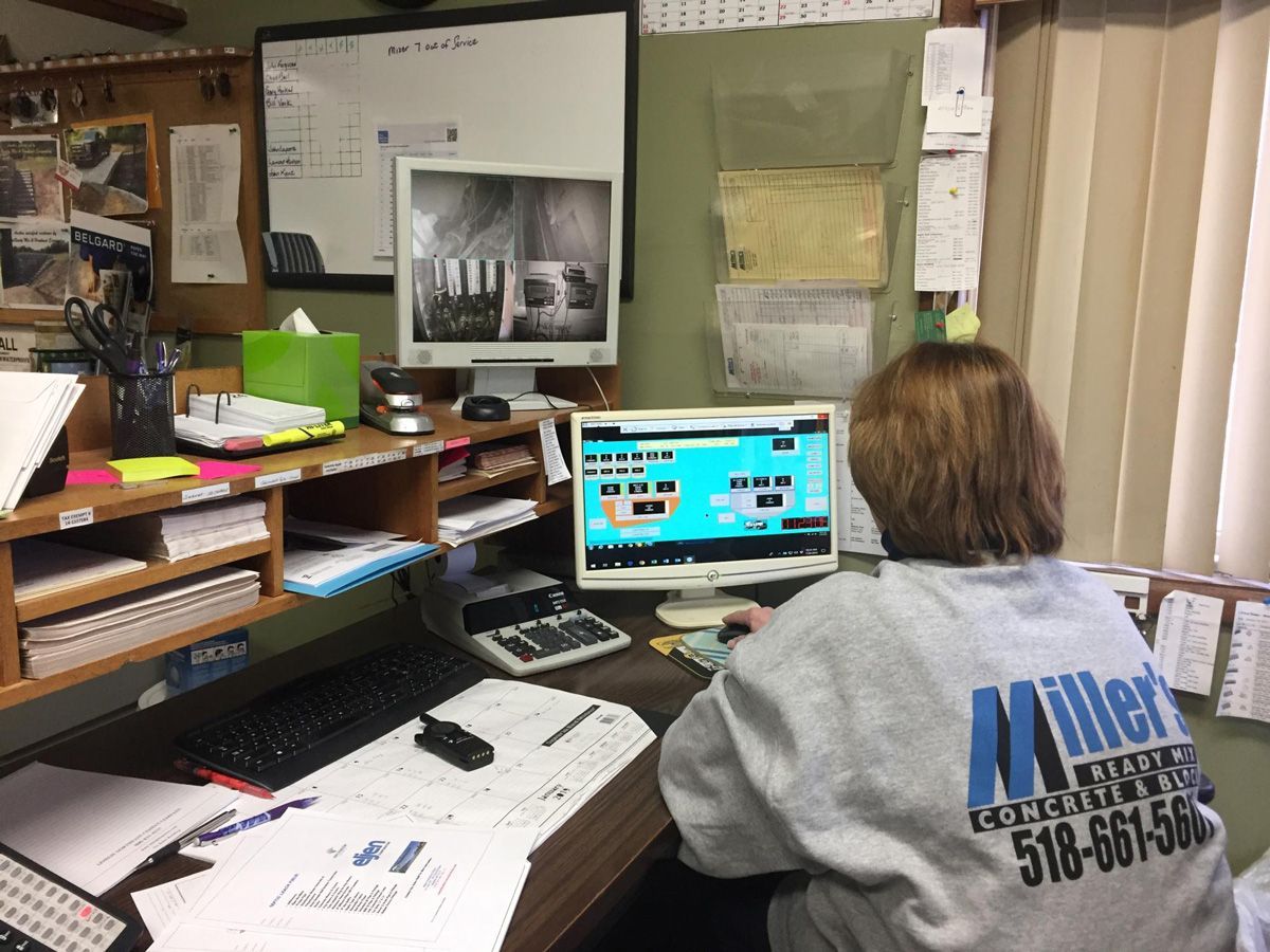 Woman Sits in Front of Computer — Mayfield, NY — Miller's Ready Mix Concrete