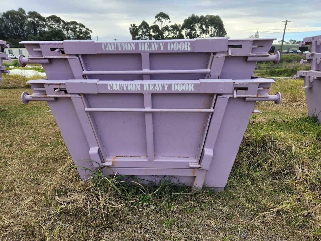 two purple skip bins with side doors are stacked — Viking Skip Bin Recycling In Bulli, NSW