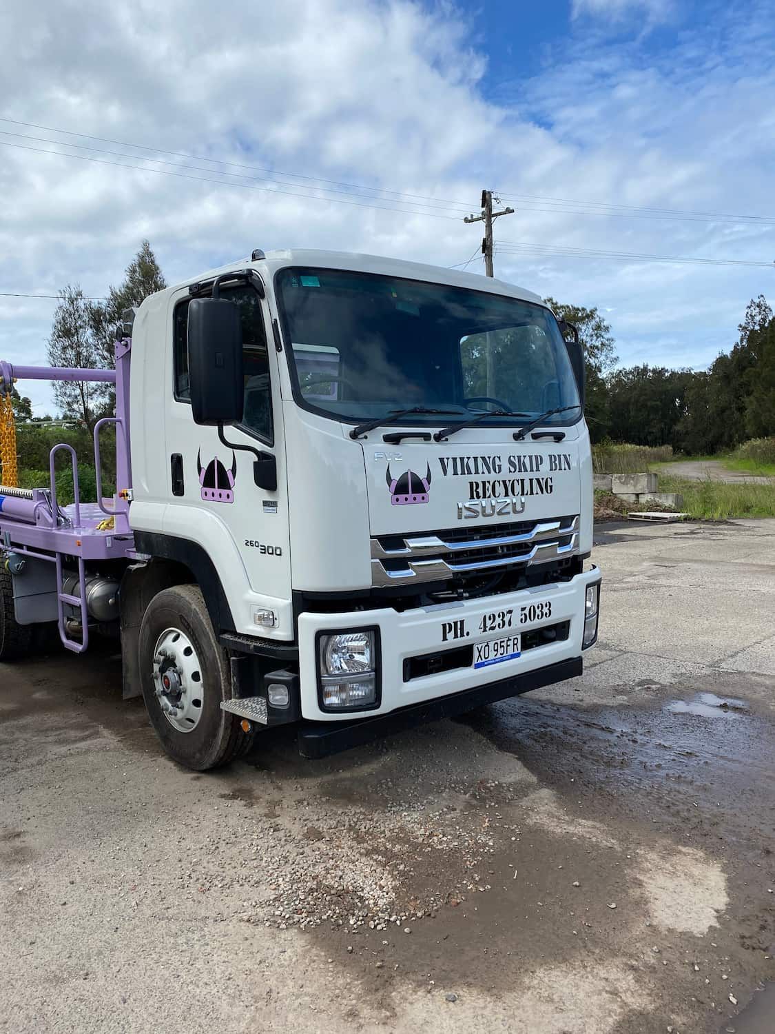 A white and purple dumpster truck — Viking Skip Bin Recycling In Bomaderry, NSW