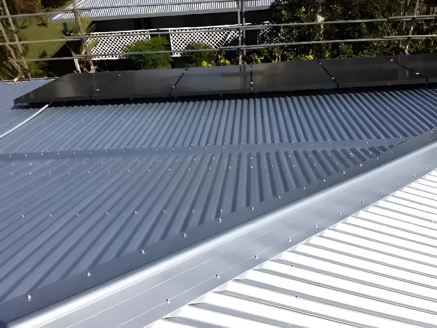 A Roof With a Lot of Solar Panels on It — Coral Coast Roofing In Earlville, QLD