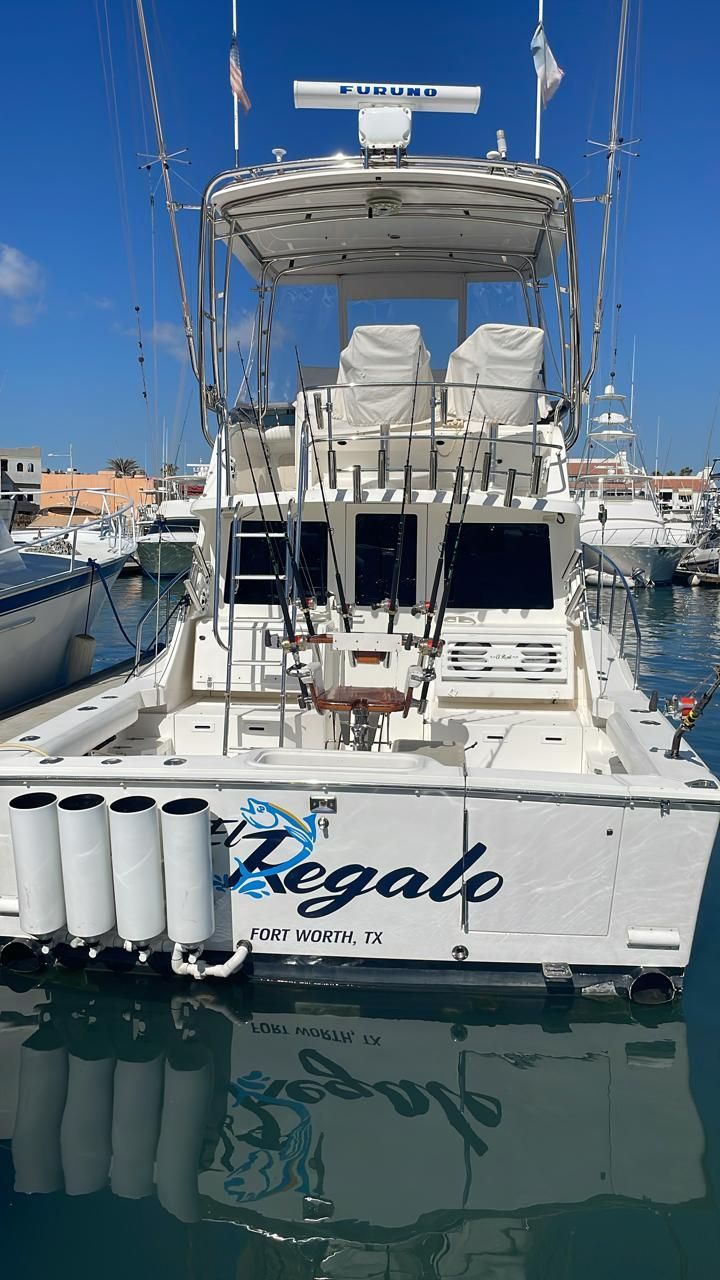 a large white boat is docked in a marina .