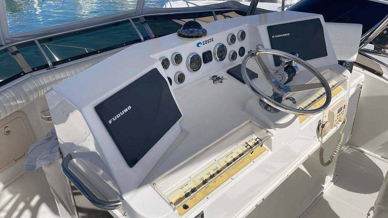 a close up of a boat 's cockpit with a steering wheel .