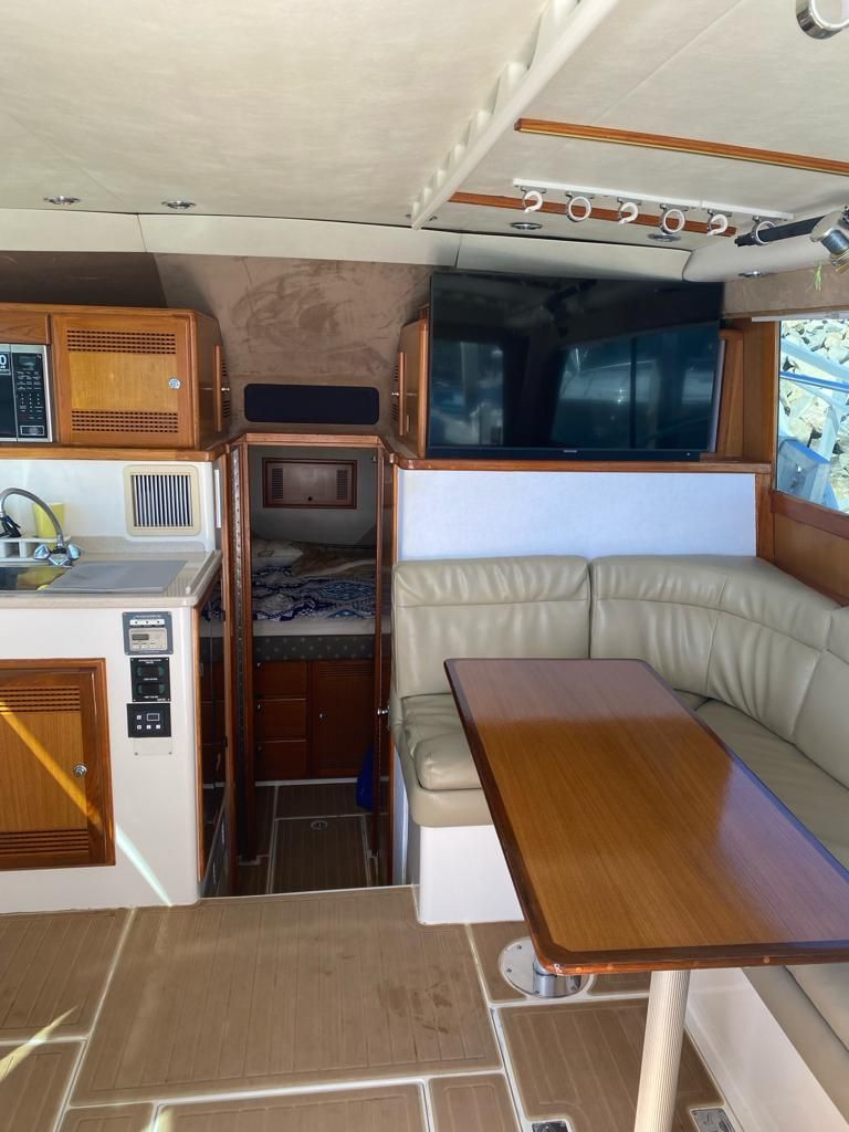 The inside of a boat with a table and couch