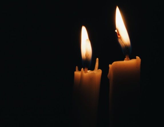Two lit candles in darkness representing funeral homes in Port Charlotte, FL.