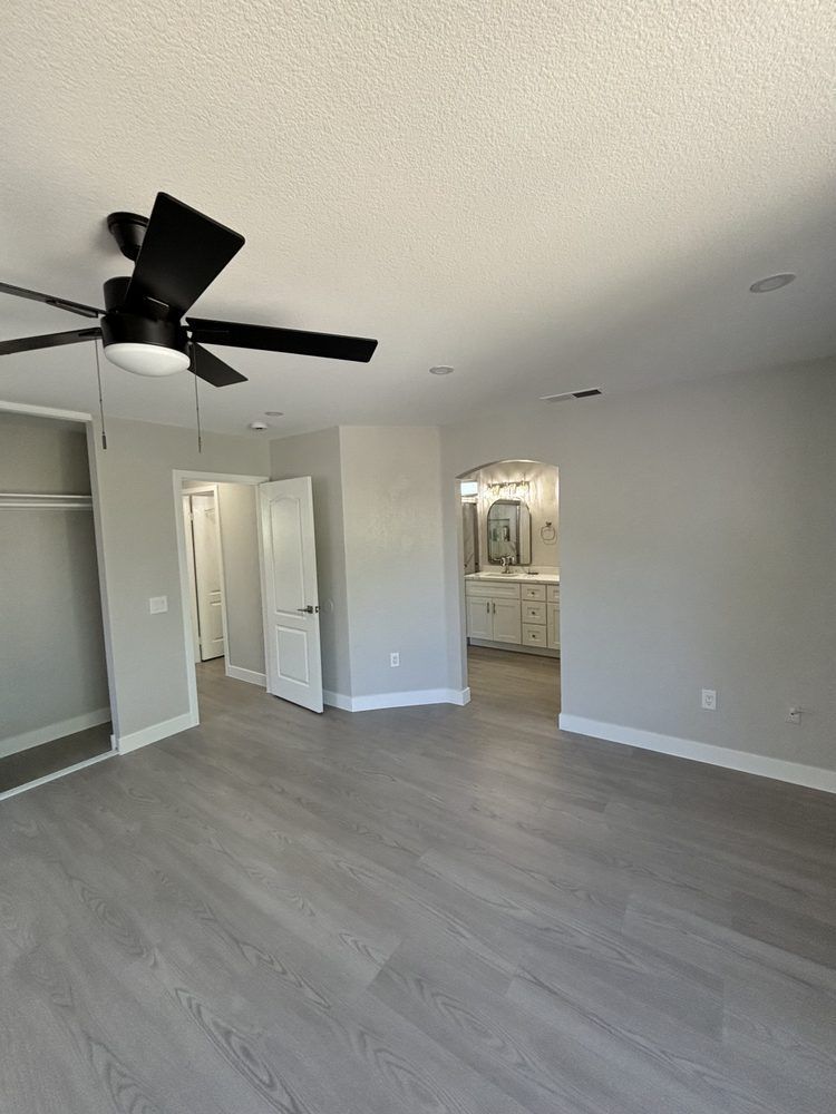 There is a ceiling fan in the middle of the room.