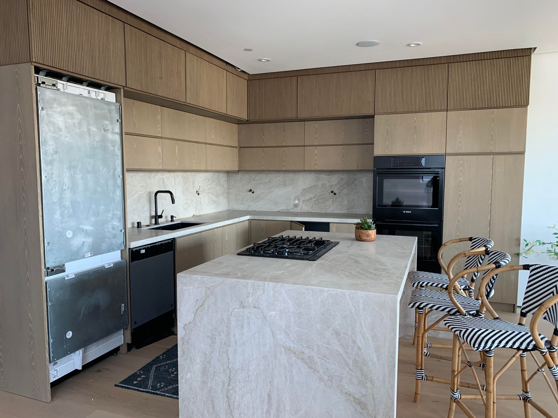 A kitchen with a large island in the middle of the room.