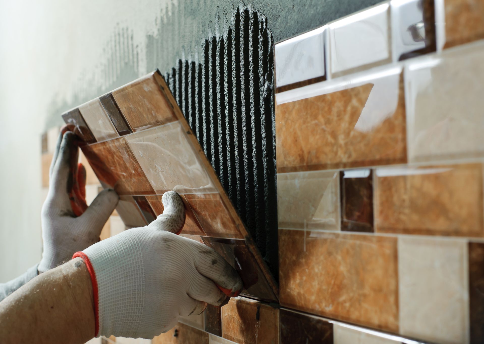 a person is installing tiles on a wall