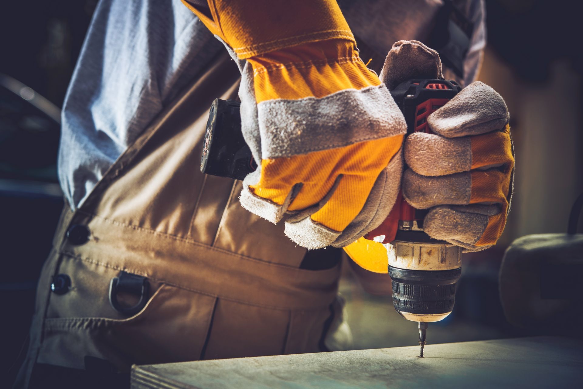 a man is using a drill to drill a hole in a piece of wood