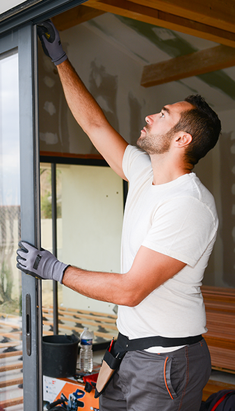 a man is installing a sliding glass door in a house